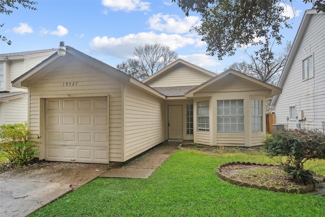 ranch-style home with a garage, driveway, a front lawn, and roof with shingles