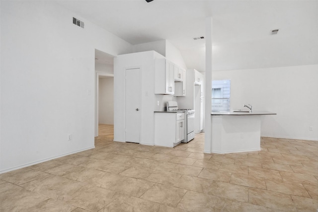 kitchen with white range with gas stovetop, visible vents, and white cabinets