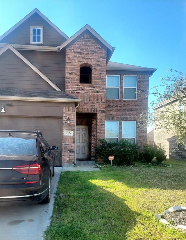 traditional-style home with a garage, brick siding, and a front lawn