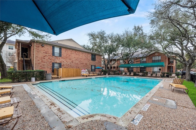 pool with stairway and fence