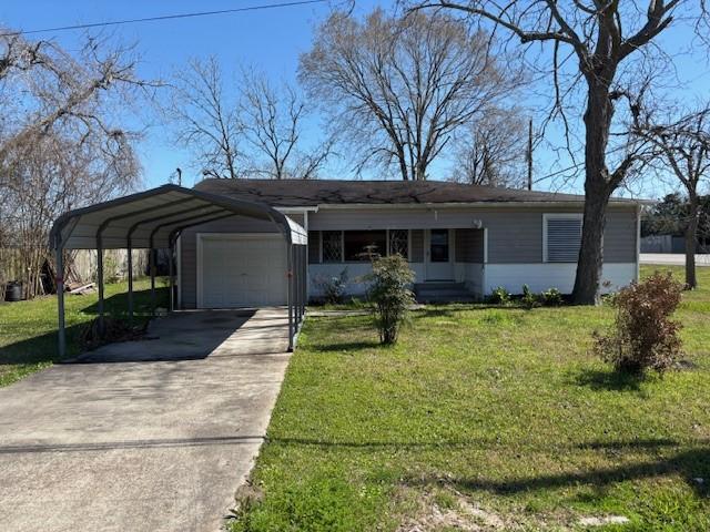 view of front of home featuring an attached garage, driveway, and a front yard