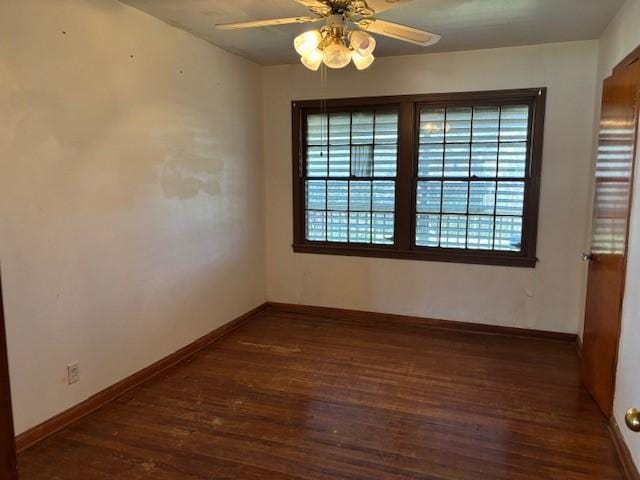 empty room with a ceiling fan, baseboards, and wood finished floors