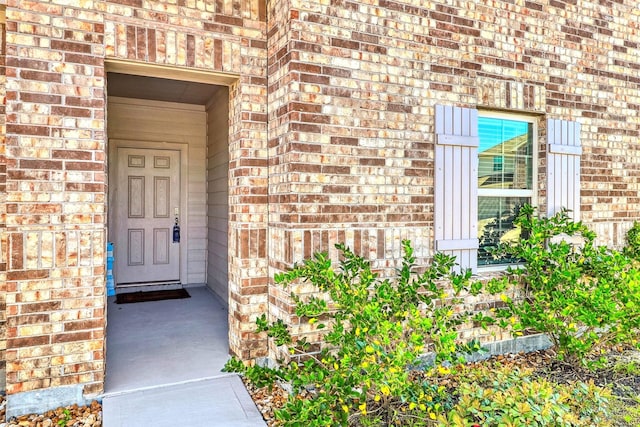 entrance to property with brick siding