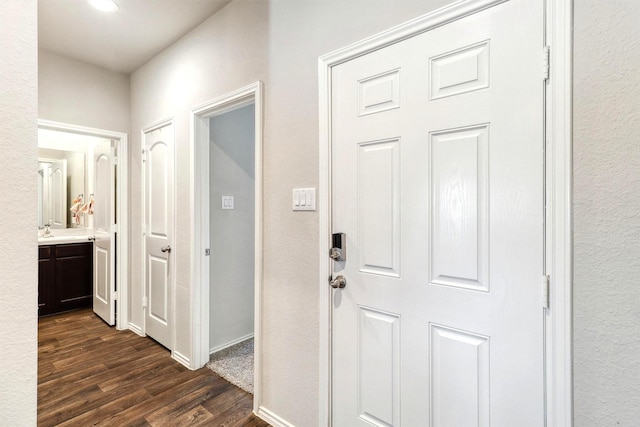 21023 Belmont Village Way, Katy, TX 77449 - corridor with dark wood-type flooring, baseboards, and a sink