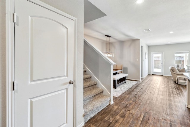 interior space featuring dark wood finished floors, stairs, recessed lighting, and baseboards