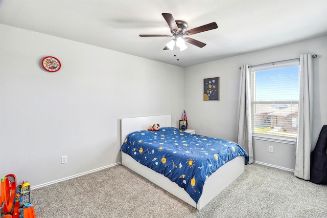 bedroom with baseboards, ceiling fan, and carpet flooring