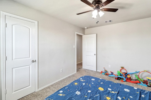 unfurnished bedroom featuring carpet flooring, baseboards, visible vents, and ceiling fan