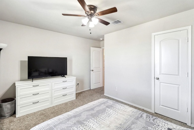 bedroom featuring visible vents, baseboards, light colored carpet, and a ceiling fan