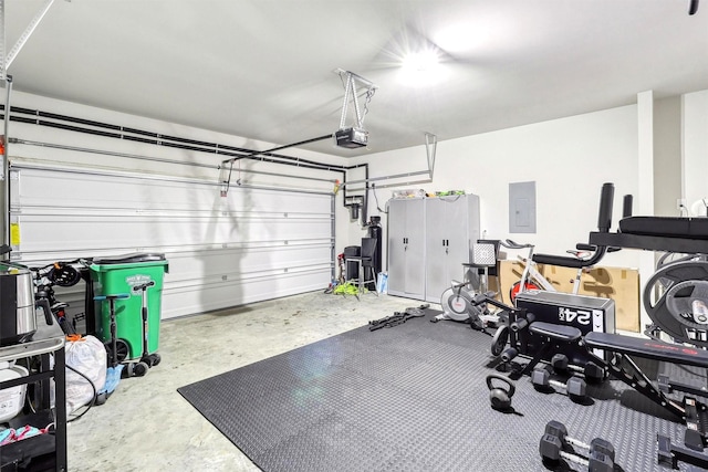 workout room featuring electric panel and a garage