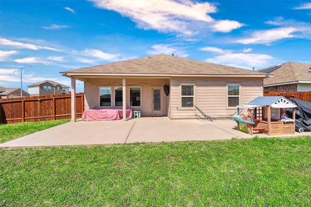 rear view of property with a yard, a fenced backyard, and a patio area