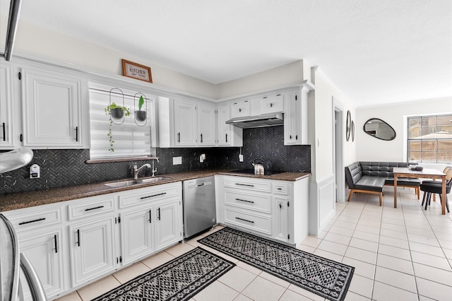 kitchen featuring dishwasher, light tile patterned flooring, a sink, and under cabinet range hood