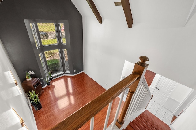 entryway featuring high vaulted ceiling, wood finished floors, and beam ceiling