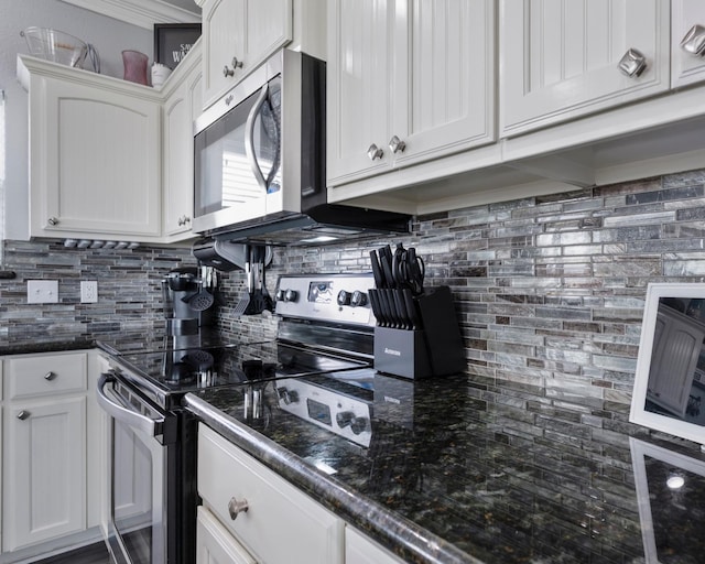 kitchen featuring white cabinets, stainless steel appliances, and decorative backsplash