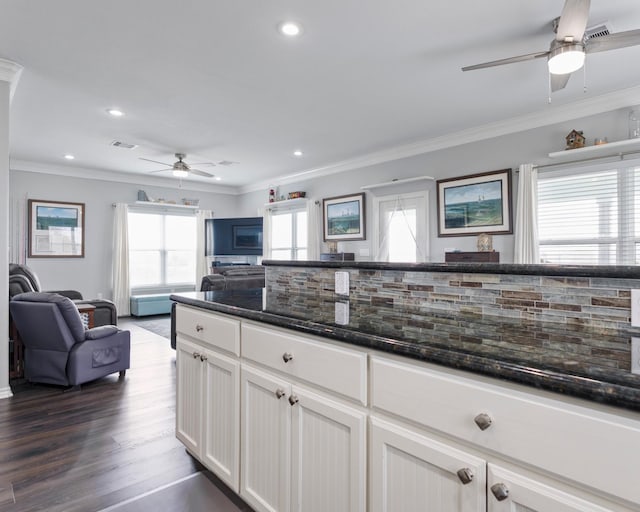 kitchen with visible vents, ornamental molding, dark wood-type flooring, open floor plan, and white cabinetry