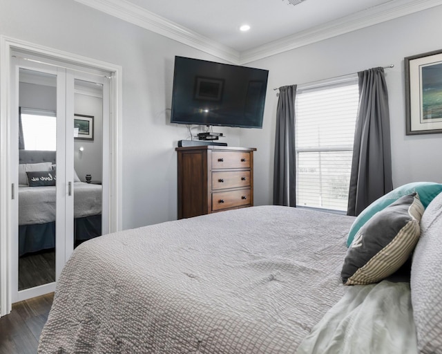 bedroom featuring recessed lighting, dark wood finished floors, crown molding, and french doors