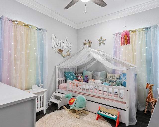 bedroom with crown molding and wood finished floors