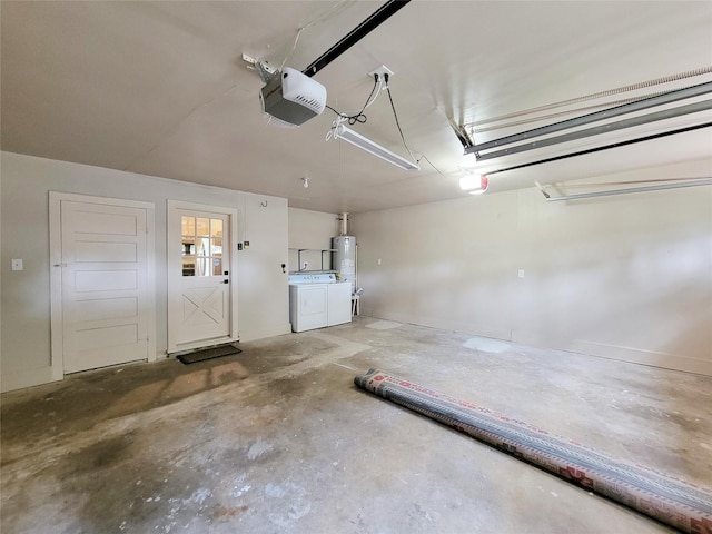 garage featuring water heater, a garage door opener, and washing machine and clothes dryer