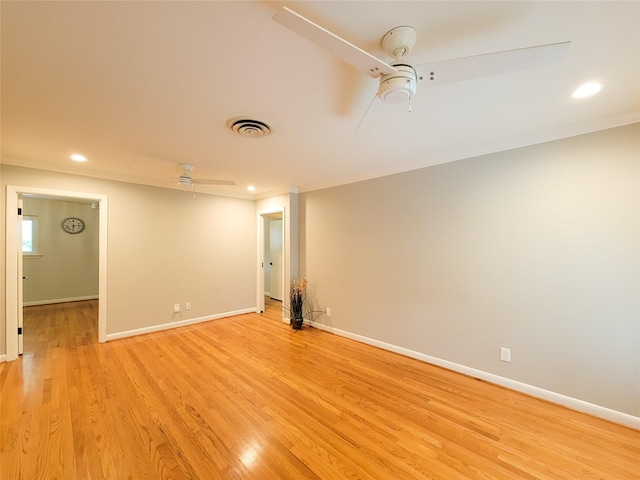 spare room with baseboards, ceiling fan, light wood-style flooring, ornamental molding, and recessed lighting