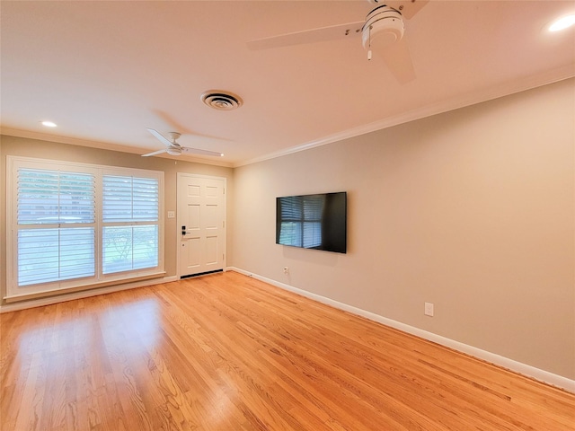 unfurnished living room with ceiling fan, light wood-style flooring, visible vents, baseboards, and crown molding