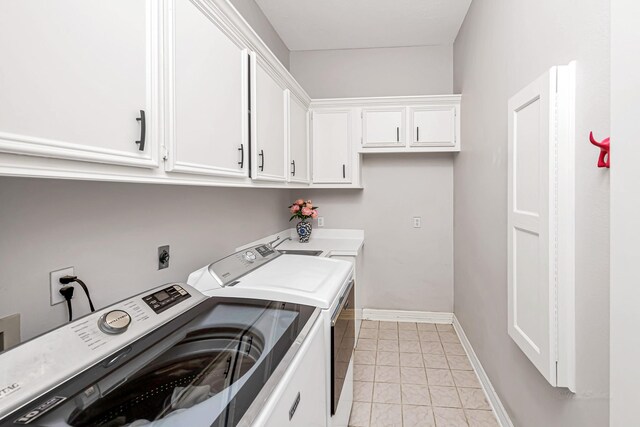 laundry room with baseboards, cabinet space, and washer and dryer