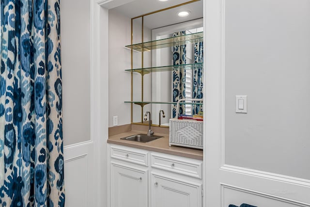 bar with indoor wet bar, a sink, and recessed lighting