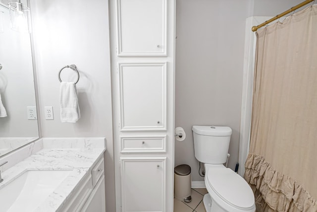 bathroom featuring toilet, vanity, baseboards, a shower with curtain, and tile patterned floors