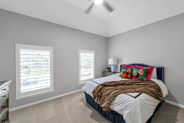 bedroom featuring baseboards, ceiling fan, vaulted ceiling, and light colored carpet