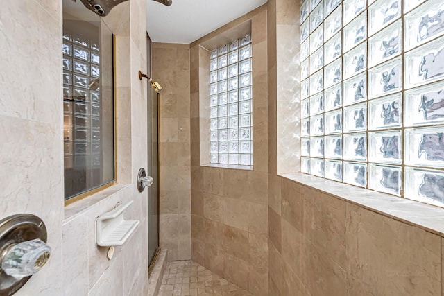 full bathroom featuring tiled shower