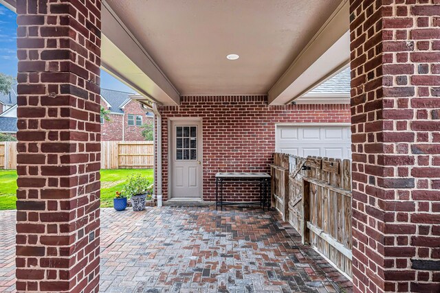 entrance to property with fence and brick siding