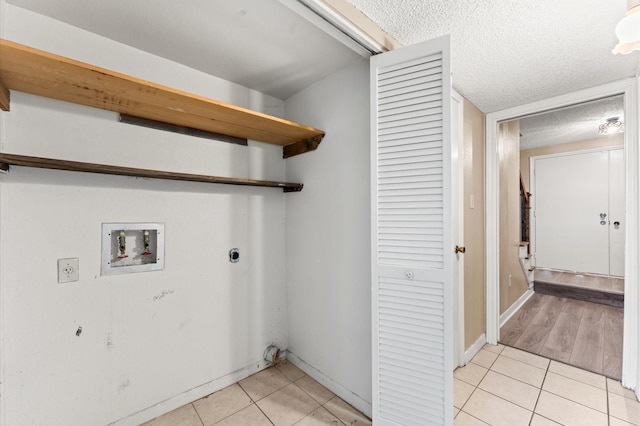 washroom with laundry area, light tile patterned floors, washer hookup, and hookup for an electric dryer