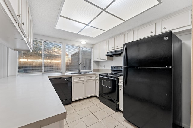 kitchen featuring light countertops, white cabinetry, a sink, under cabinet range hood, and black appliances