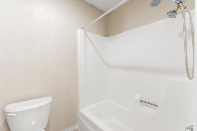 full bathroom with baseboards and toilet