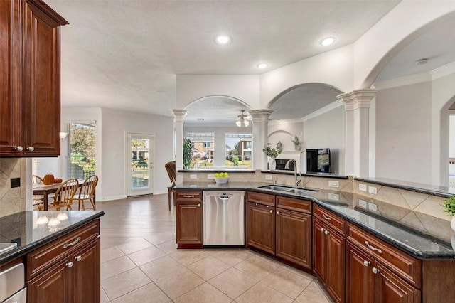 kitchen with dishwasher, backsplash, open floor plan, ornate columns, and a sink