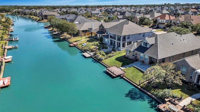 bird's eye view featuring a water view and a residential view