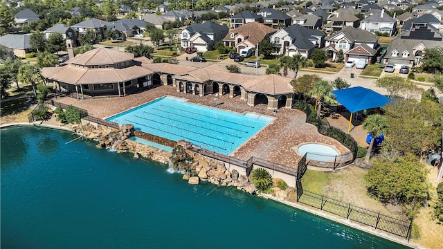 community pool featuring a residential view, fence, and a patio