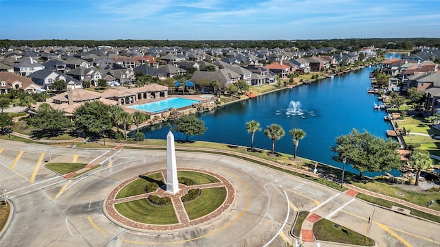 drone / aerial view featuring a water view and a residential view