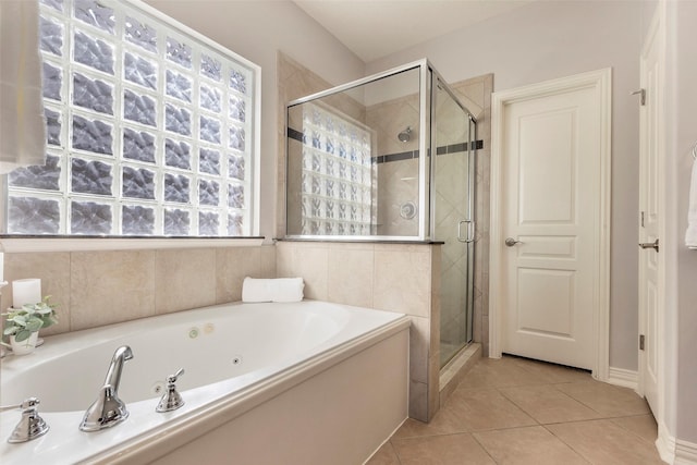 bathroom with tile patterned flooring, a shower stall, and a bath