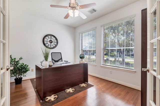 home office with dark wood-style floors, a wealth of natural light, french doors, and baseboards