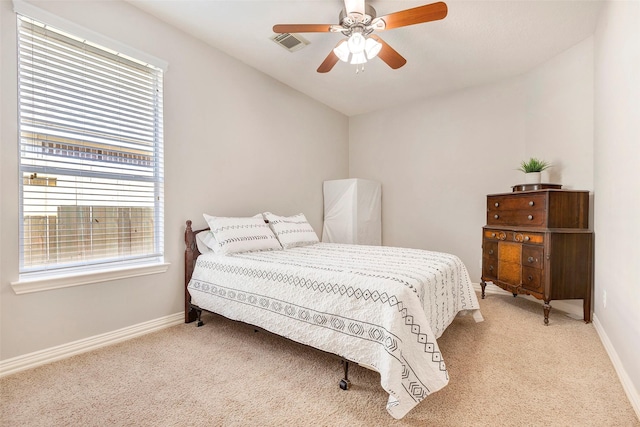 carpeted bedroom with visible vents, ceiling fan, and baseboards