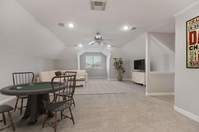 carpeted dining room with vaulted ceiling, a ceiling fan, visible vents, and baseboards