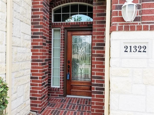 property entrance with brick siding