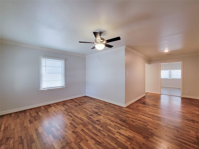 unfurnished room with ornamental molding, ceiling fan, baseboards, and wood finished floors