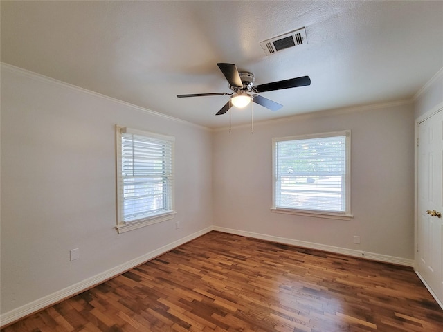 spare room with visible vents, a healthy amount of sunlight, and baseboards