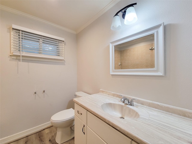 full bath with vanity, wood finished floors, baseboards, crown molding, and toilet