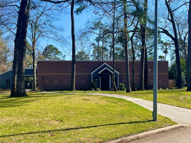 view of front of home with a front yard and concrete driveway