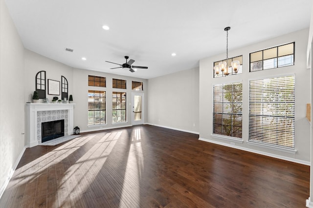 unfurnished living room with recessed lighting, a fireplace, visible vents, baseboards, and dark wood-style floors