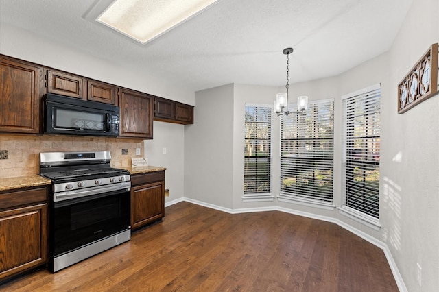 kitchen with black microwave, a notable chandelier, dark wood-type flooring, tasteful backsplash, and gas stove