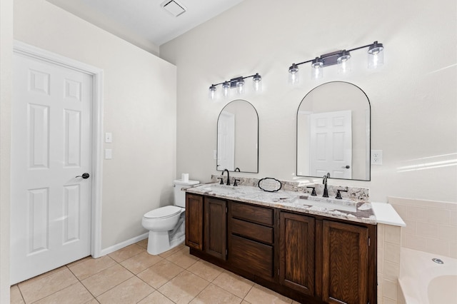 bathroom with double vanity, a tub to relax in, visible vents, tile patterned flooring, and a sink