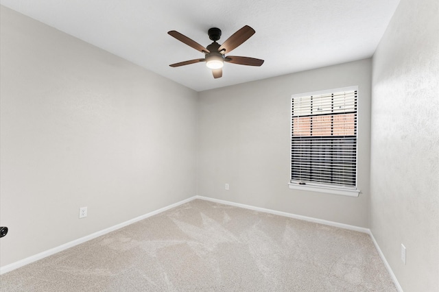 empty room with light carpet, baseboards, and a ceiling fan