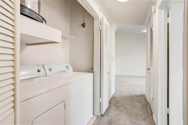 laundry area with laundry area, separate washer and dryer, and light colored carpet